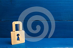 A wooden padlock on a blue background, information, entrance. Wooden figures of persons carry guards from wicked men, spies. conce