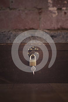 Wooden padlocked box on floorboards