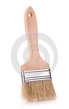 Wooden paint brush close-up on white background.