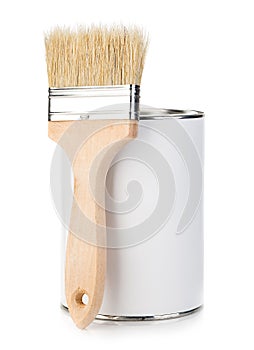 Wooden paint brush with paint tin close-up on white background.