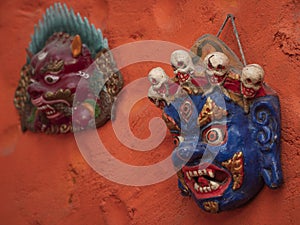 Wooden painted masks representing Mahakala and protector Garuda from buddhist believes.