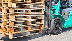 Wooden pallets stack at the freight cargo warehouse for transportation and logistics industrial, Driver forklift loading