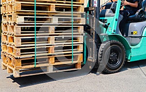 Wooden pallets stack at the freight cargo warehouse for transportation and logistics industrial, Driver forklift loading
