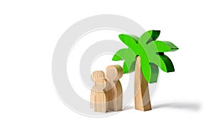 Wooden palm tree and family on an isolated background. Family holidays with children. Tours and cruises to warm countries.