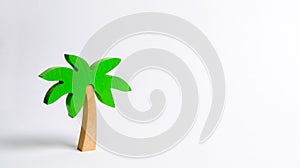 Wooden palm tree on a white background. Conceptual leisure and vacation, entertainment and relaxation. Tours and cruises to warm