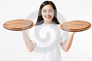 Wooden pan. Young asian woman in summer tshirt holding empty pizza tray isolated on white background. Copy space and mock up.