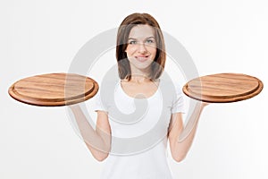 Wooden pan. Young woman in summer tshirt holding empty pizza tray isolated on white background. Copy space and mock up. Blank
