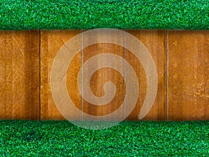 Wooden panel with green grass for background