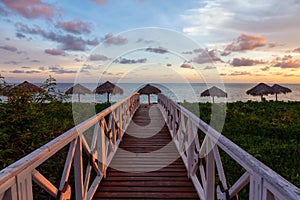 Wooden path leading to the sandy beach on the Caribbean Sea in Cuba