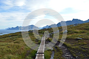 Wooden path in mountains near Kvalvika beach