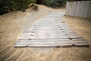Wooden path on sand