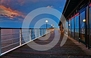 Wooden path and railing on the pier in Heringsdorf in the evening. Baltic Sea island Usedom. Germany