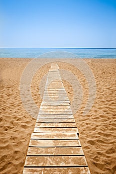 Wooden path to the sandy beach