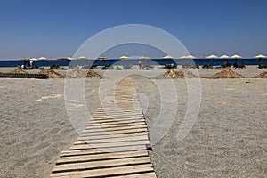 Wooden path to the sandy beach, Greece