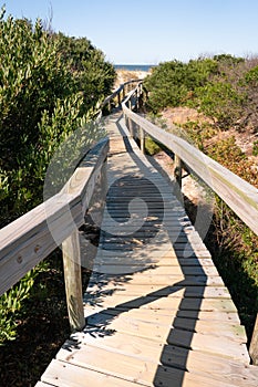 Wooden pathway with a handrail inSanta Lucia del Este Canelones beach in uruguay
