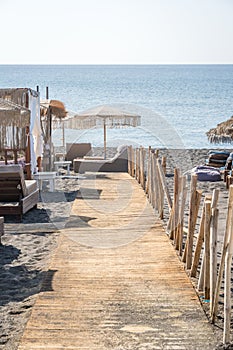 Wooden pathway on Pervivolos Beach in Santorini