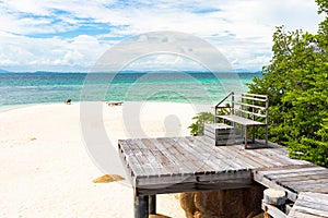 Wooden pathway and wooden chair built on a rocky coast  at Koh Munnork island , Rayong, Thailand