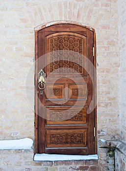 Wooden pattern in door with boor handle in Tashkent, Uzbekistan photo