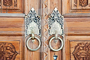 Wooden pattern in door with boor handle in Tashkent, Uzbekistan photo