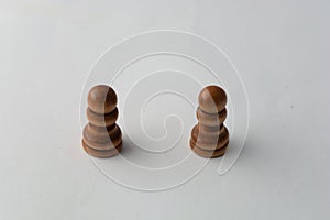 Wooden paws chess figure on grey background