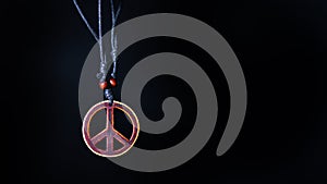 Wooden peace symbol attached to string necklace fairies love not