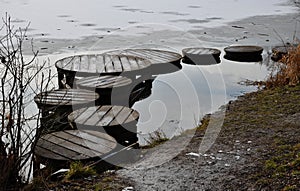 wooden pedestrian bridge over frozen snowy river pond lake  no railing