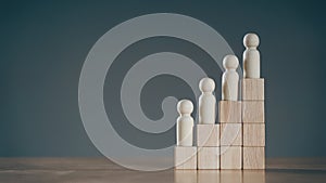 Wooden peg dolls on Stack of wooden blocks. Employees positions. Human resource management planning