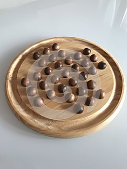 Wooden peg solitaire board game