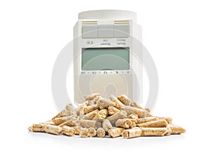 Wooden pellets and thermostatic valve head isolated on white background. Biomass - Renewable source of heating