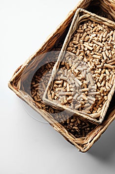 Wooden pellets in two wicker boxes. Biomass fuel