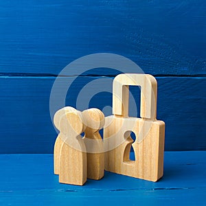 Wooden people with padlocks. Confiscation of property for debts. Safety and alarm system. Security service. three people