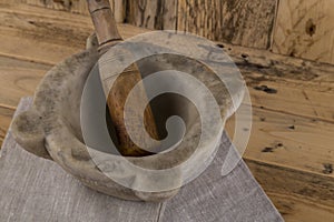 Wooden pestle and stone mortar