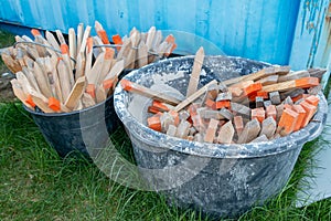 Wooden picket posts in plastic barrels