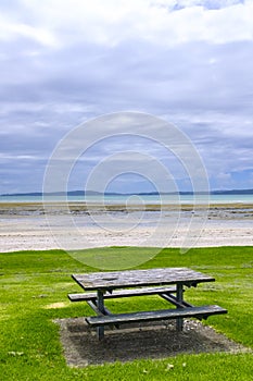 Wooden picnic table by a beach