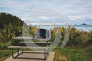 Wooden picnic table at the beach near Dunedin, South Island, New Zealand