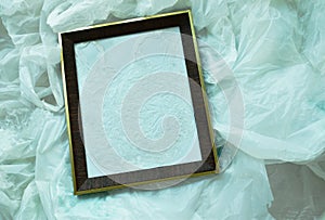 Wooden picture frame on white plastic bag packing stacking