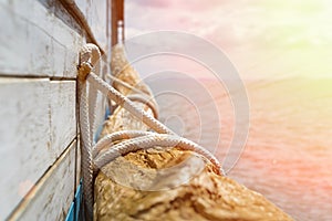 Wooden piece decoration next to a pier during sunset with warm colors - holidays vacations and summer concept.