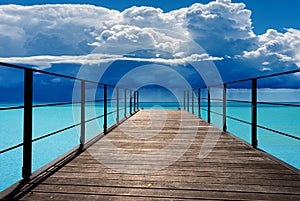 Wooden Pier Against a Beautiful Turquoise Seascape with Storm Clouds