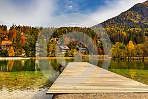 Wooden pier on amazing lake Jasna in autumn season