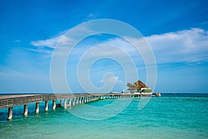Wooden pier with blue sea and sky background