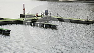 Wooden pier for boats on the river bank