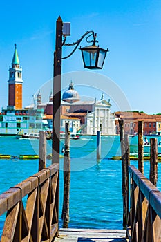 Wooden pier and boats on San Marco basin Venice Italy