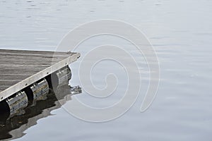 wooden pier detail on dark water. Wooden dock detail.