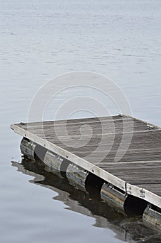 wooden pier detail on dark water. Wooden dock detail.