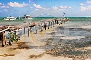 Wooden pier dock, boats and ocean view at Caye Caulker Belize Ca