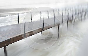 Wooden pier with fast flowing water