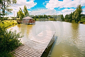 Wooden Pier For Fishing, Small House On Small Lake Or River