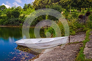 Wooden pier or jetty and a boat on lake sunset and sky reflection water.