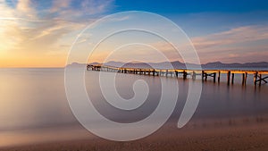 Wooden pier / jetty, playa de muro, Alcudia, sunrise, mountains, secluded beach, golden sunlight, reflection, beautiful sky,