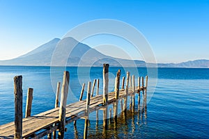 Wooden pier at Lake Atitlan on the beach in Panajachel, Guatemala. With beautiful landscape scenery of volcanoes Toliman, Atitlan photo